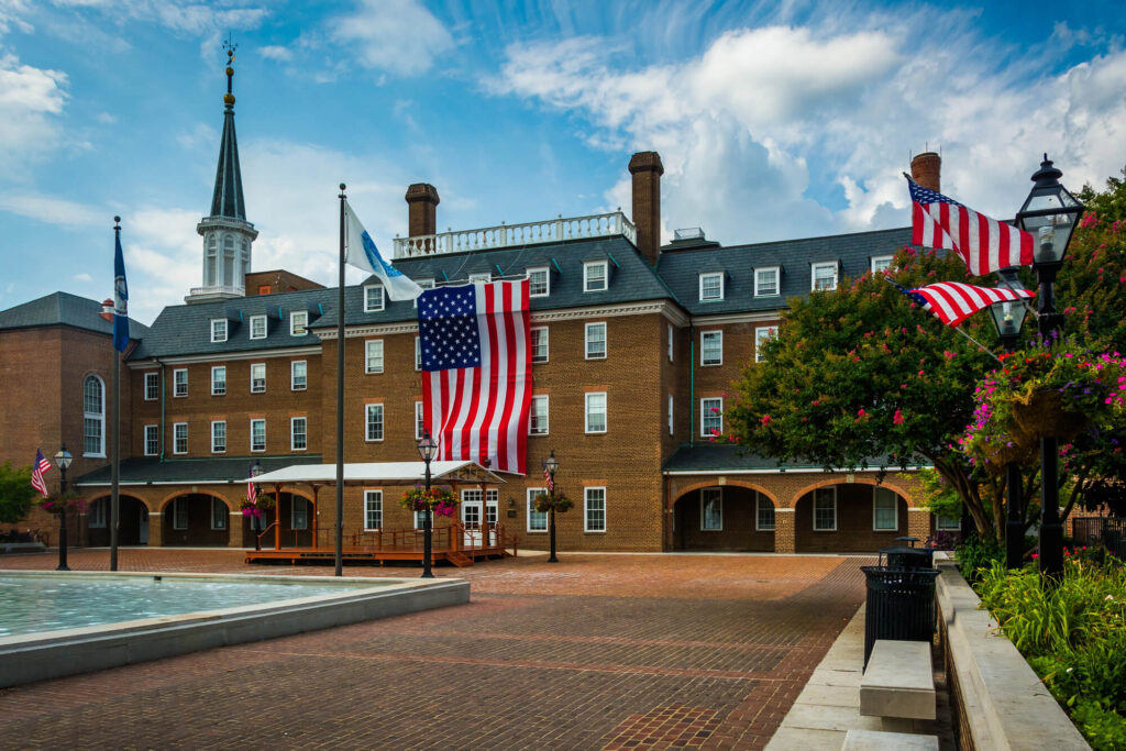 Historic Alexandria City Hall decorated with American flags, representing the Northern Virginia mobile physical therapy service area | Castine Concierge Physical Therapy | Mobile Physical Therapy Services Washington DC